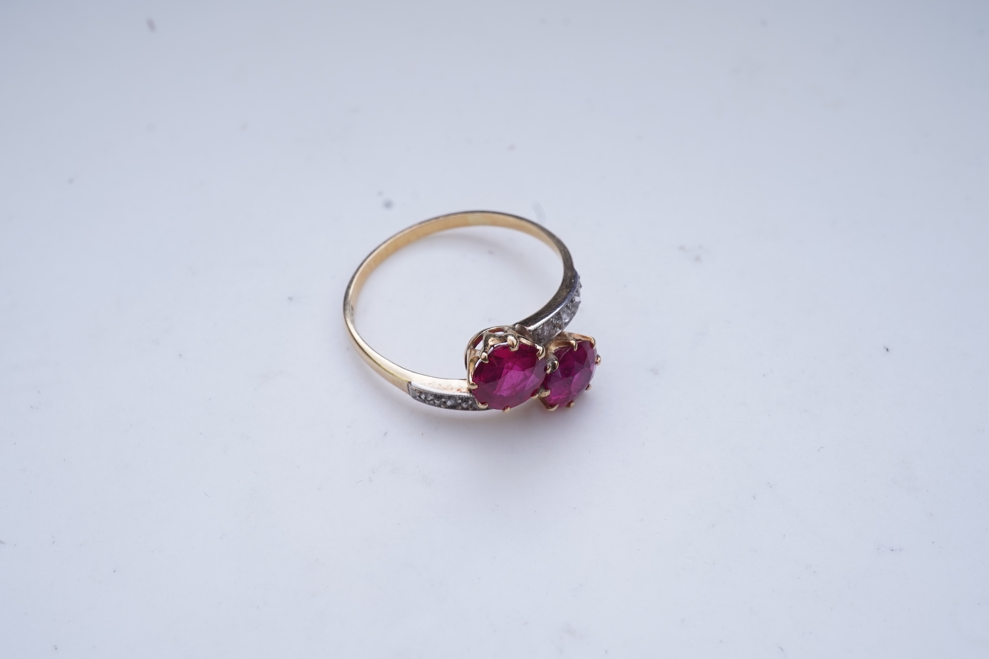 A synthetic ruby and diamond 'toi-et-moi' ring, early 20th century